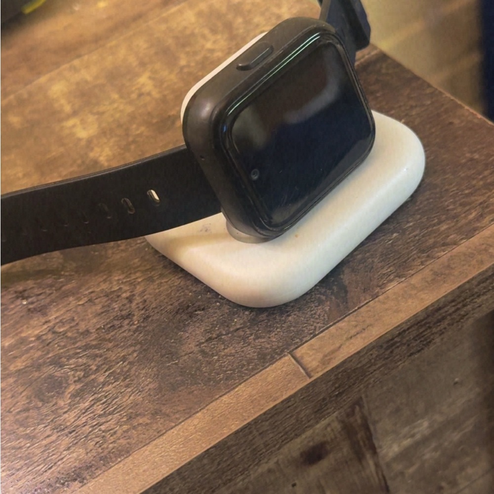 Black Smartwatch with White Charging Dock